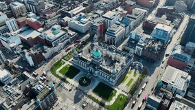 Aerial video of Belfast City Hall Cityscape Skyline on a sunny day in Northern Ireland 