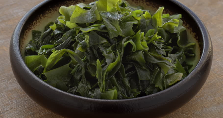 Wakame seaweed in a bowl. Asian cuisine food ingredient. Table spin.