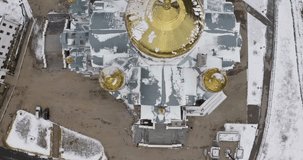  View of the beautiful church with golden domes. Clip. A huge Khrestyansky temple taken from a helicopter decorated with various patterns.