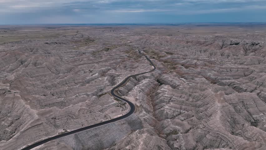 Wide aerial view of Highway 240 passing through the South Dakota Badlands.