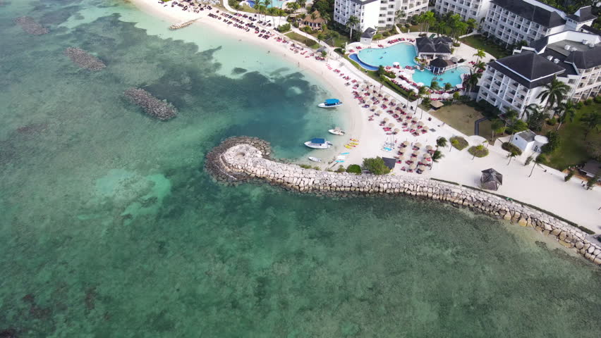Aerial drone view flying towards the sandy beach in Montego Bay, Jamaica, Caribbean sea
