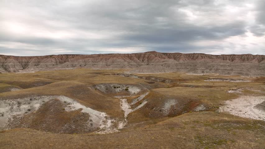 Aerial view passing over the mountainous prairie in the Badlands.