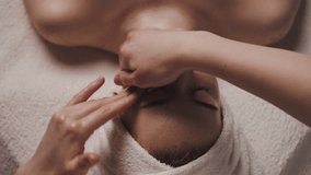 Beautiful woman with closed eyes relaxing in spa salon getting face massage in beauty spa. Serene woman relaxing in a beauty center. Professional beauty salon. - Powered by Shutterstock - Get 15% off with code: PIKWIZARD15