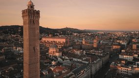 bologna city center aerial view drone at sunrise,flying forward close to asinelli tower at dawn