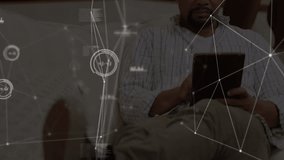 Animation of networks of connections with icons over man using smartphone. global technology, digital interface and connections concept digitally generated video.