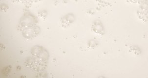 4K footage vertical video Top view SLO MO CU, milk being poured into a container making lots of bubbles.