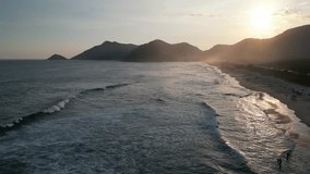 Grumari Beach, Rio de Janeiro, Brazil. Sunset on the beach with lots of waves. Great place for surfing and bodyboarding. video drone Top View 4k.
