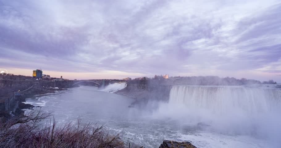 time lapse of changing day to night at niagara falls waterfall with lights turned on