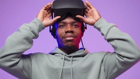 Young  american man in hoodie puts on virtual reality helmet the first time. - Powered by Shutterstock - Get 15% off with code: PIKWIZARD15