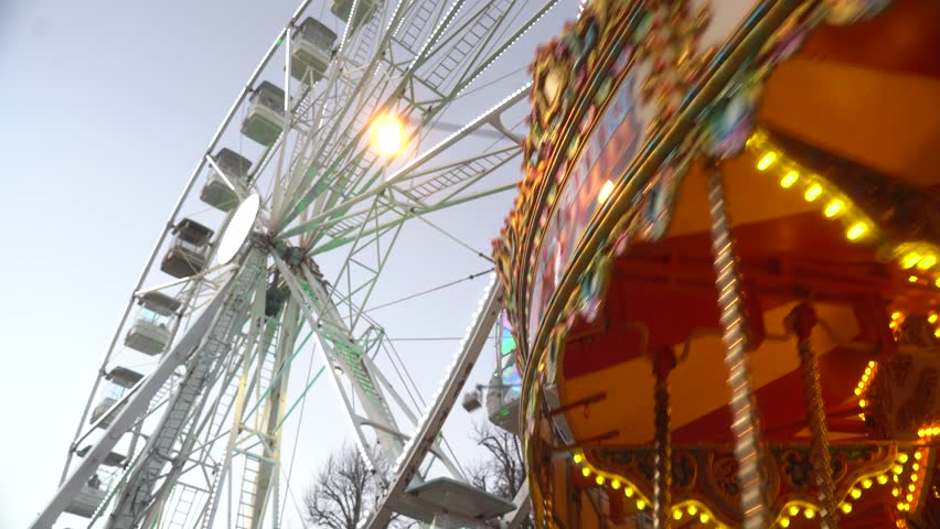 Carousel is spinning in front of the Ferris wheel. Kilkenny. ireland. 2023 Royalty-Free Stock Footage #1101873287