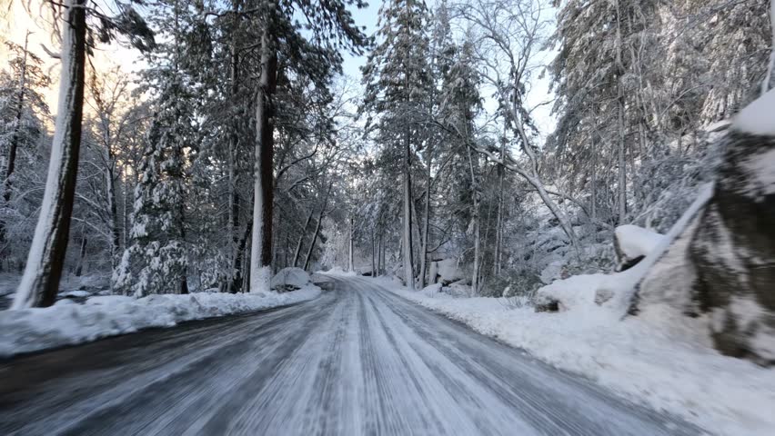 Driving through Yosemite Valley during a snowy winter in Yosemite National Park, California. | Shutterstock HD Video #1101876791