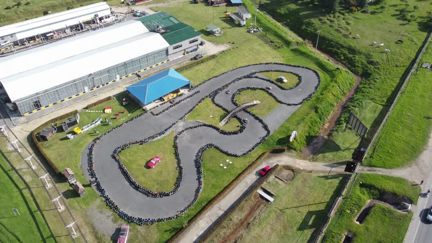 Aerial footage of new go kart race track racing grass area sunny day