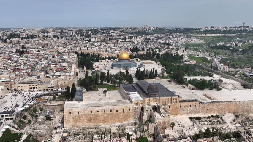 Al Aqsa golden dome of the rock and Jerusalem old city, aerial

Drone view from the old city of Jerusalem, 4K, march, 2023 
