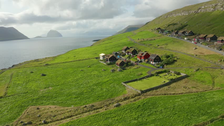 4k drone forward video (Ultra High Definition) of Kirkjubour village. Attractive morning scene of Faroe Islands, Denmark, Europe. Traveling concept background.