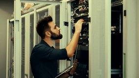 System Engineer Control Room IT Administrator. Server Engineer Work On Laptop in Data Center. Male Server IT Engineer Work Data Center. Man Work In Server Room. Male Typing On Laptop In Server Room - Powered by Shutterstock - Get 15% off with code: PIKWIZARD15