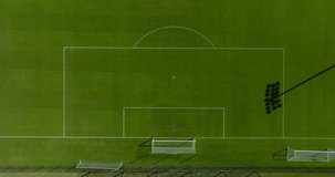 4K aerial view of an empty soccer field outdoors with freshly mowed grass, crisp white lines, cross hatches, and an inspirational view perfect for text as a video background.
