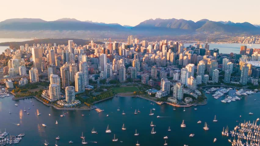 Vancouver downtown skyline aerial crane up shot, British Columbia, Canada at sunset