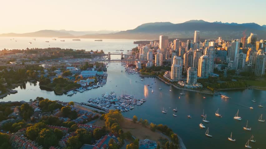 Vancouver downtown skyline aerial flythrough over marina, British Columbia, Canada at sunset Royalty-Free Stock Footage #1101882727