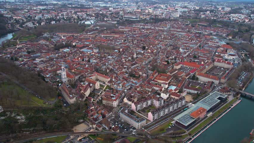 Aerial around the old town of the city Besancon in France on a cloudy afternoon in late winter | Shutterstock HD Video #1101883233