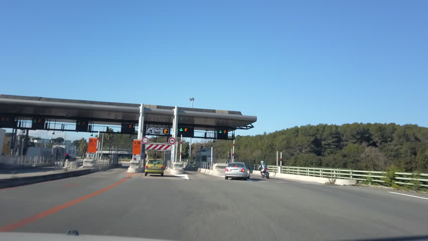 Using toll booth - autoroute péage - on French motorway on sunny day in the South of France. Royalty-Free Stock Footage #1101883317