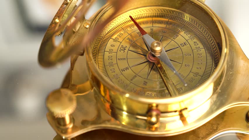 Brass compass on rotating on the mirror. Modern sailor gold brass compass. Macro shot | Shutterstock HD Video #1101883623
