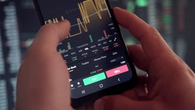 Businessman trader using smartphone checking stock exchange. Man using mobile phone with investing application. Stock market investment and trading cryptocurrency on app in hand. Online business data - Powered by Shutterstock - Get 15% off with code: PIKWIZARD15