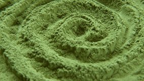 Chlorella or spirulina algae green powder is spinning, rotation. Dietary supplement to improve health. Seaweed superfood. Healthy food background. Vitamins and minerals to diet. Detox. Close up video.