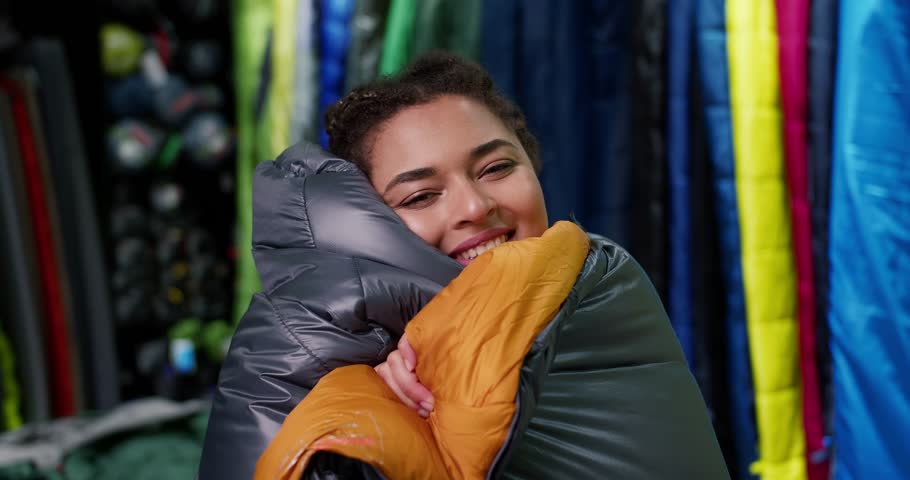 Portrait of a woman covered in sleeping bag at tourist store