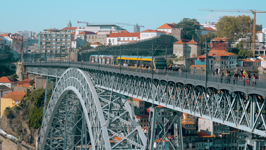 Beautiful view of city with bridge and metro. Action. Landscape of summer city with bridge over river and surface subway. Metro train is moving on beautiful bridge on sunny summer day | Shutterstock HD Video #1101885161