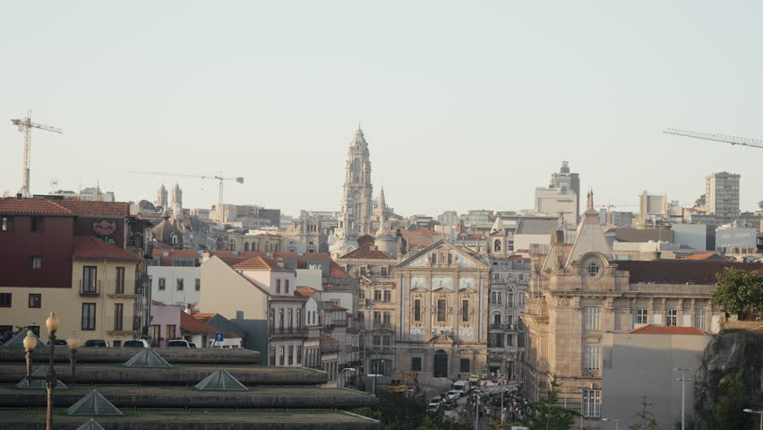 Panorama of ancient European city with construction cranes. Action. Ancient towers and buildings in European city in morning sun. Beautiful old town with tower and modern construction cranes | Shutterstock HD Video #1101885187