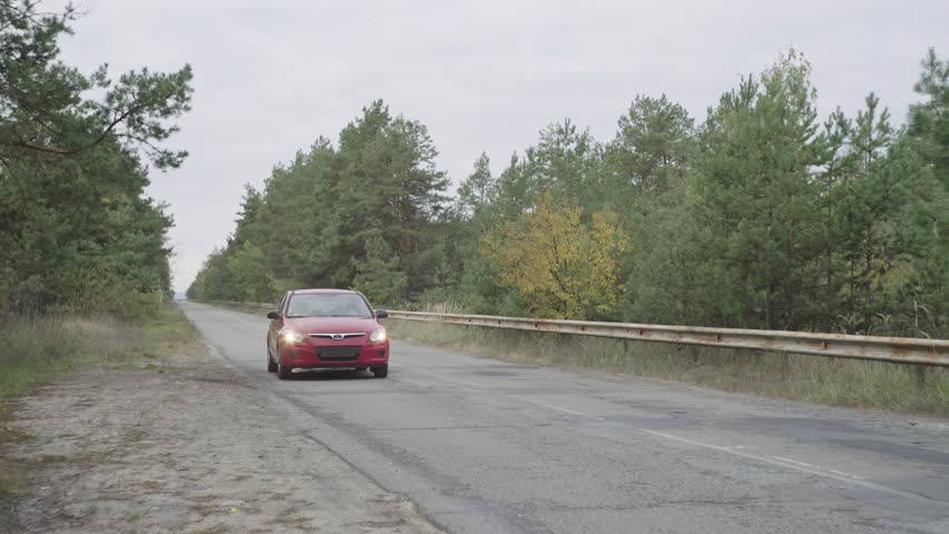 The red car stops on the side of the road due to a malfunction, a flat tire, or a broken engine. Upset driver. An emotional man near a car in which a technical malfunction occurred. Need help. 4k | Shutterstock HD Video #1101885669