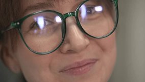 woman with glasses looks at the camera. slow-motion video.close-up.High-quality FullHD video recording