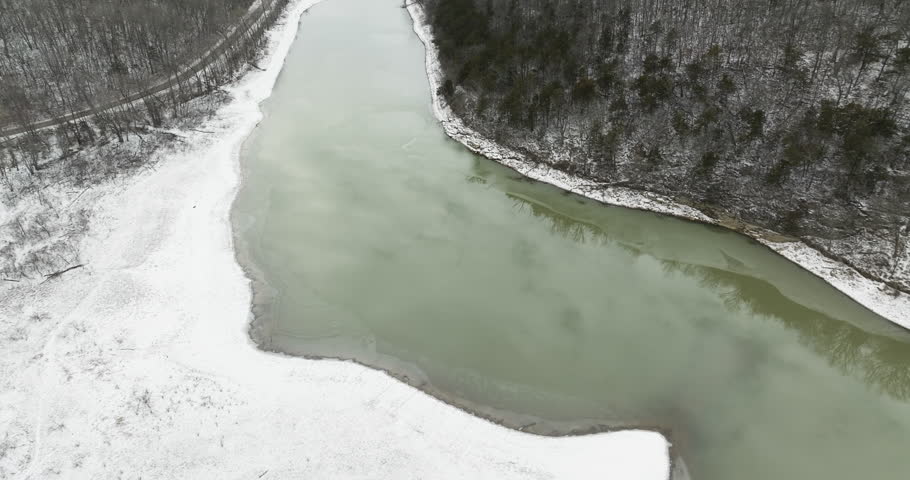 White River And Bare Trees On Mountain Slope During Winter Season In Fayetteville, Arkansas, USA. - aerial