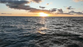 Flying low over ocean at sunrise. Aerial view of drone flight over sea in sunset. Camera files towards sun rising over the ocean. Shot off the Black point coast line, Yorke Peninsula, South Australia - Powered by Shutterstock - Get 15% off with code: PIKWIZARD15