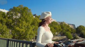 Attractive girl with a yellow bicycle near the river Seine in Paris