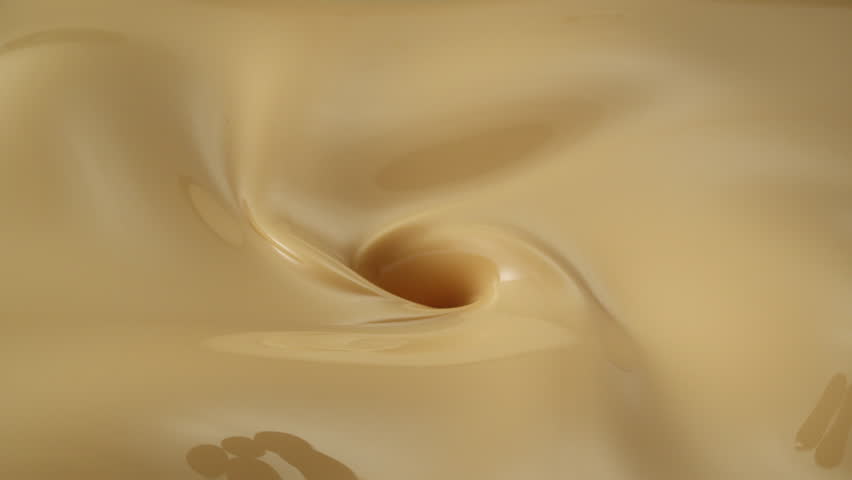 pouring cherries into vanilla ice cream mixture