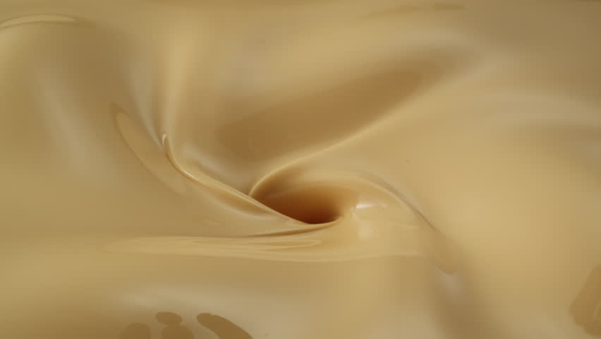 pouring cherries into vanilla ice cream mixture