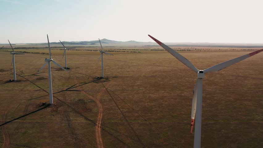 Wind Power Turbines Generating Clean Renewable Energy for Sustainable Development. Drone Flies Over a Windmill Park. Renewable energy production for green ecological world. | Shutterstock HD Video #1101889619
