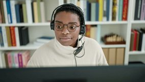 African american woman student smiling confident having video call at library university