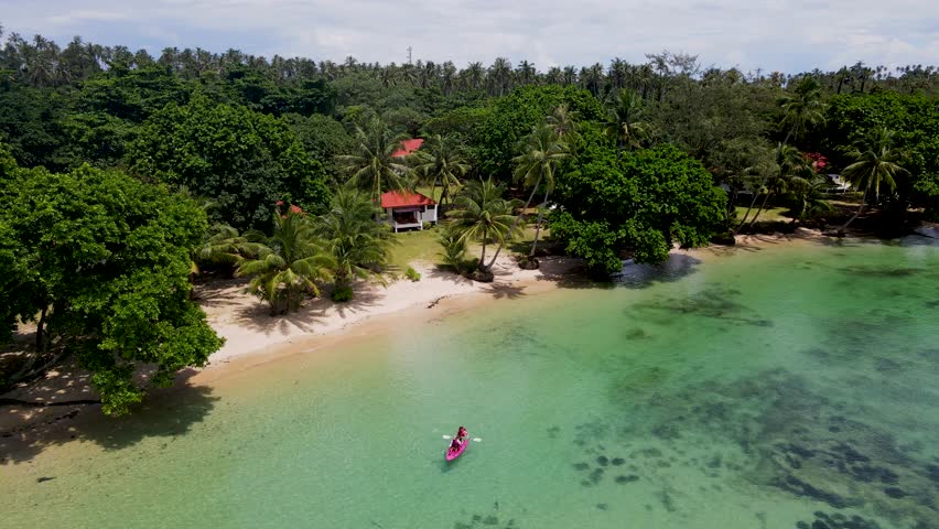 A couple of men and women in a kayak on the tropical island Koh Chang Thailand, drone view at the kayak. 