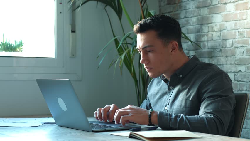 Tired male student or worker sit at home office desk look in distance having sleep deprivation, lazy millennial man distracted from work feel lazy lack motivation, thinking of dull monotonous job
 Royalty-Free Stock Footage #1101897471