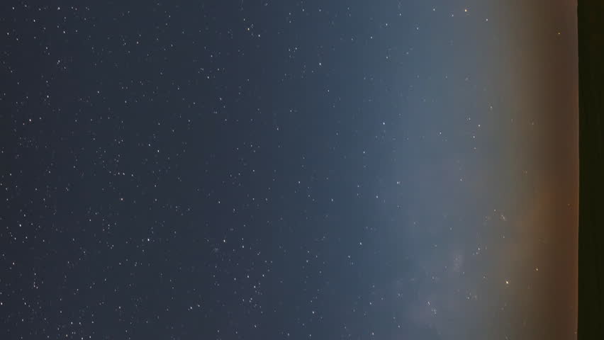 vertical footage Milky Way Galaxy In Night Starry Sky Above Lonely Tree In Summer Meadow. Glowing Stars And Meteorite Trails Above Landscape. View From Europe.