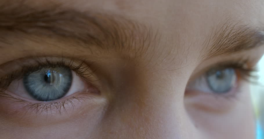 Blue Eye of Child Looking Intro Distance Close Up. Macro Shot Opening and Closing Blue Eyes Little Girl. Close Up Motion of Children Eyes. Human eye iris opening pupil.