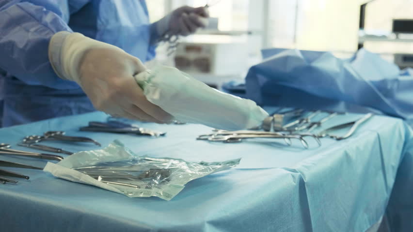 Preparation for the surgery. Surgery tools. Multiple surgery tools on the table in operating room. Scrub nurse hands in rubber gloves. Modern medical concept. Royalty-Free Stock Footage #1101900341