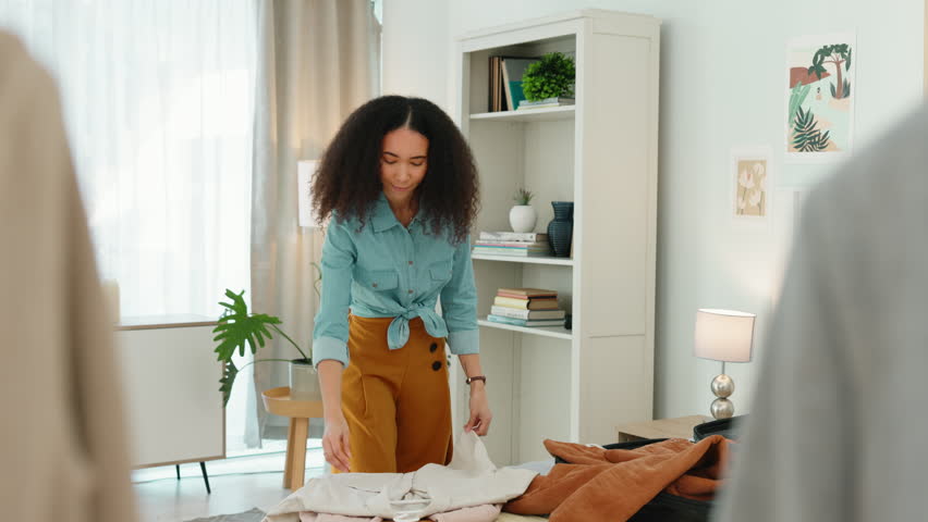 Holiday packing, black woman and luggage at home with person holding vacation clothing. Bedroom, woman and travel female ready for a adventure, journey or cruise with a suitcase and bag in a house