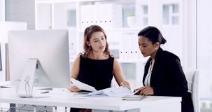 I can definitely think of ways to improve. 4k video footage of a two young attractive businesswomen sitting in the office and going through paperwork during a meeting.