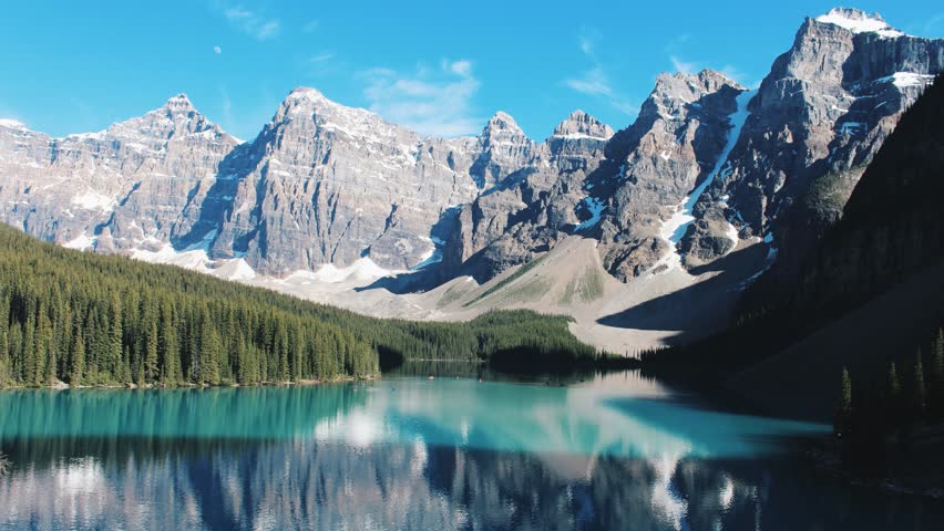 shot of Lake Moraine in Banff National Park. Mountains of famous Ten Peaks reflecting in the beautiful calm turquoise water of the lake. Banff National Park, Alberta province in Canada. Royalty-Free Stock Footage #1101907651