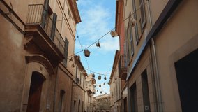 Abandoned alley in Mallorca with a blue sky backdrop. Straw hats sway in the wind on ropes across the street. Shot in slow-motion. Calming video. Perfect for relaxation or as a background.
Clip 006
