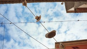 Abandoned alley in Mallorca with a blue sky backdrop. Straw hats sway in the wind on ropes across the street. Shot in slow-motion. Calming video. Perfect for relaxation or as a background.
Clip 002