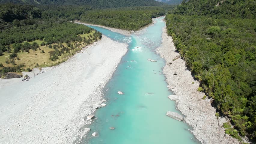 Beautiful colouful scene of confluence two rivers and pristine forest, New Zealand natural landscape - drone shot
